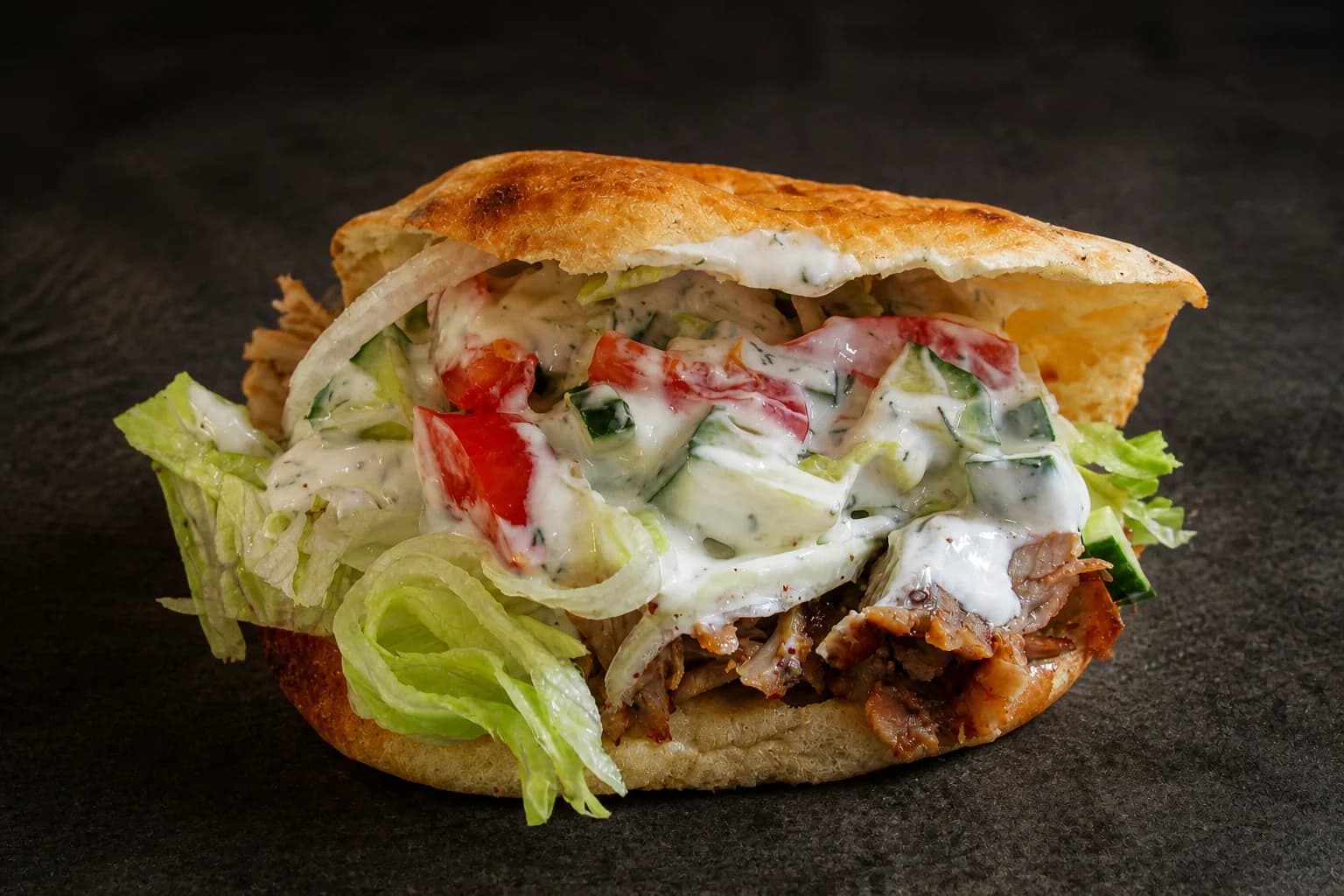 Filled kebab showing sliced meat beneath the vegetables